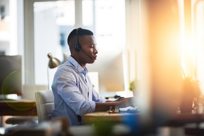 man with headset setting up email marketing automations